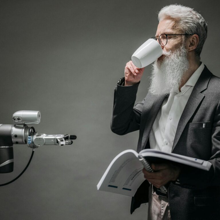 A senior man interacts with a robot while holding a book, symbolizing technology and innovation.